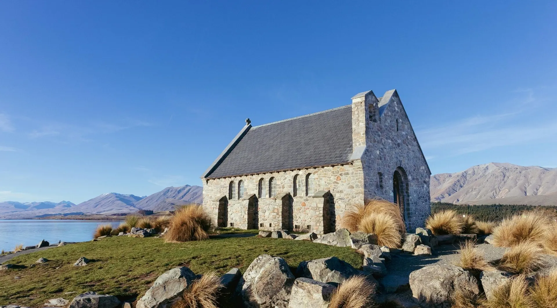 Stone church beside Lake Tekapo in daylight